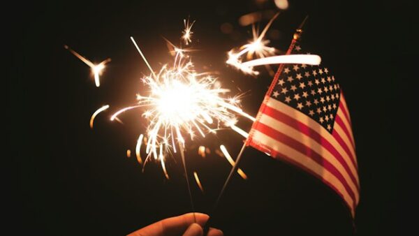 A photo of USA flag with fire crackers celebrating 4th of july event